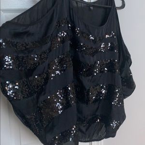 Super Cute Bebe, off the shoulder, sequined shirt.